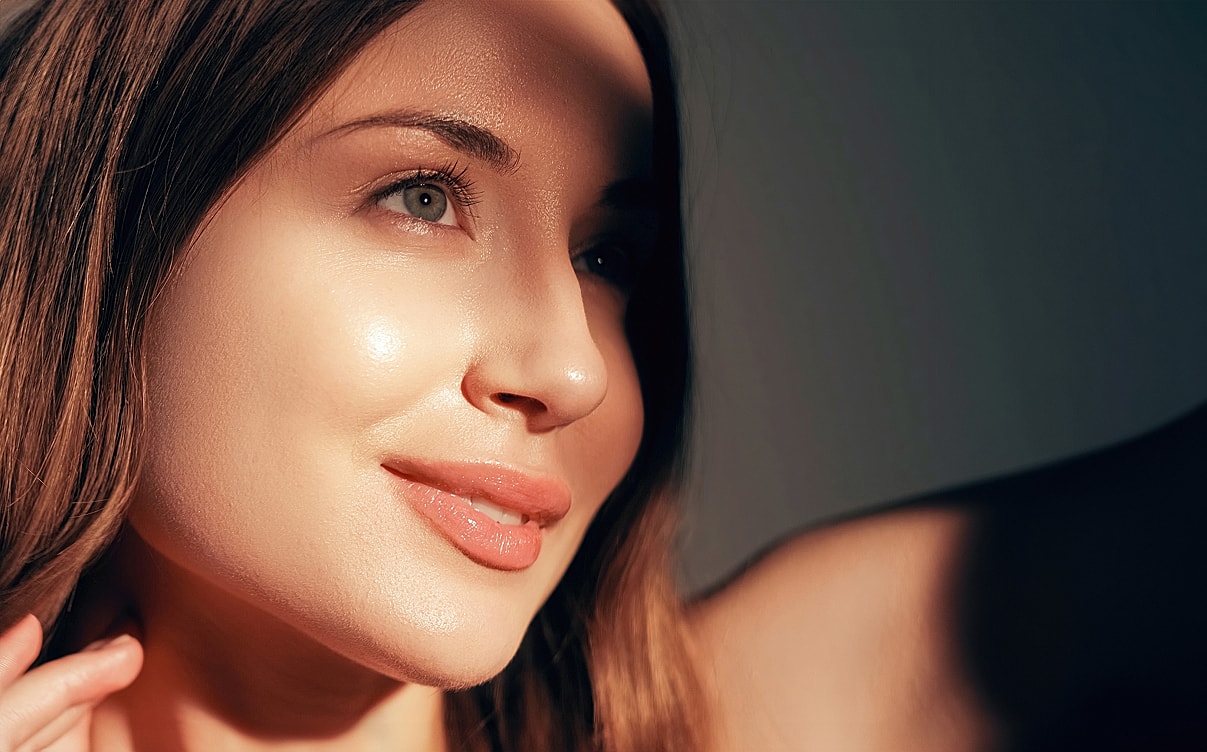 Close-up of a woman's face in soft light.