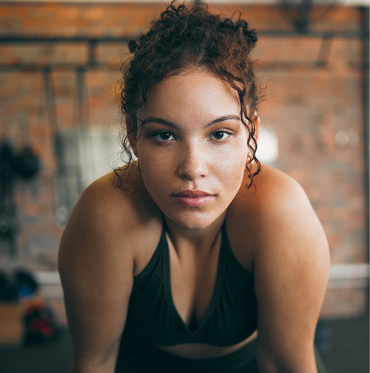 Young woman focused in fitness attire.