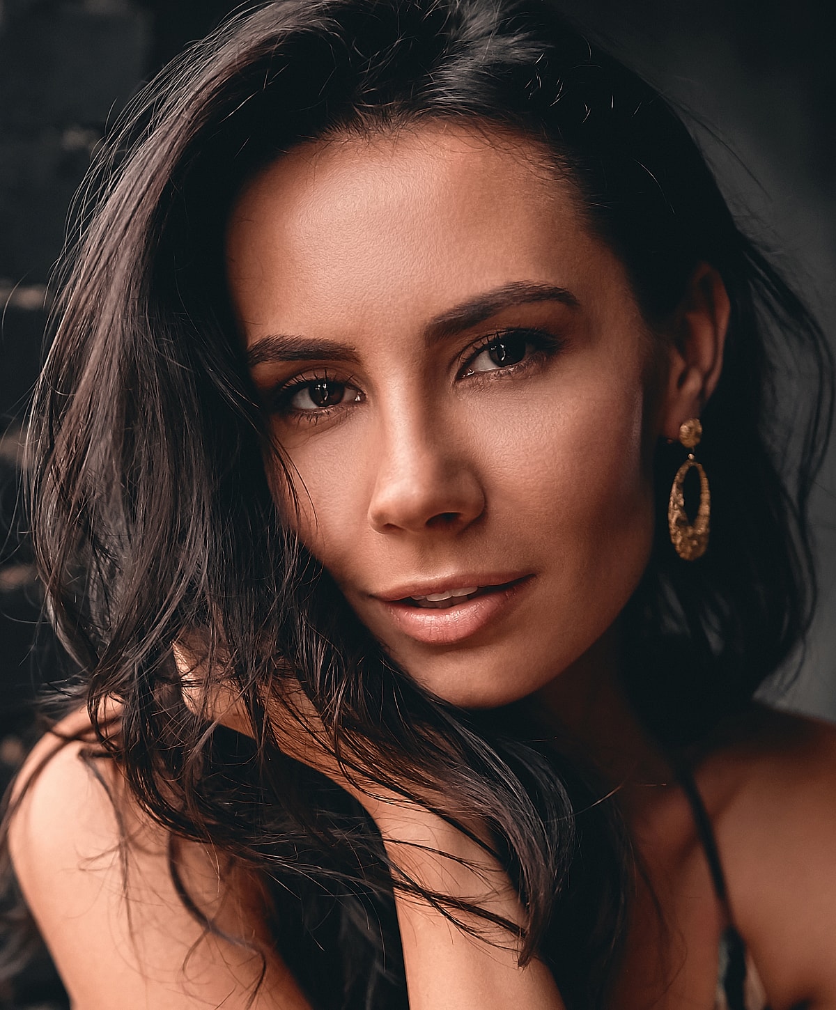 Close-up portrait of a woman with earrings.